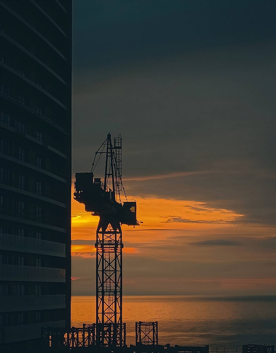 "Steel meets sky", a crane stands tall against the fading fire of dusk, where human ambition and nature’s calm converge.

Taken from OnePlus Nord CE2

Taken from: OnePlus Nord CE 2