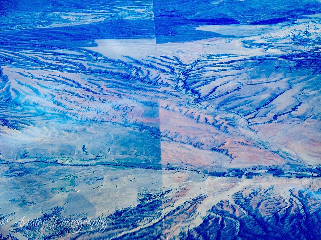 There are no straight lines in nature. 

This looks like 2 photos badly stitched together but it is in fact the Southern Border Wall between the US and Mexico. 