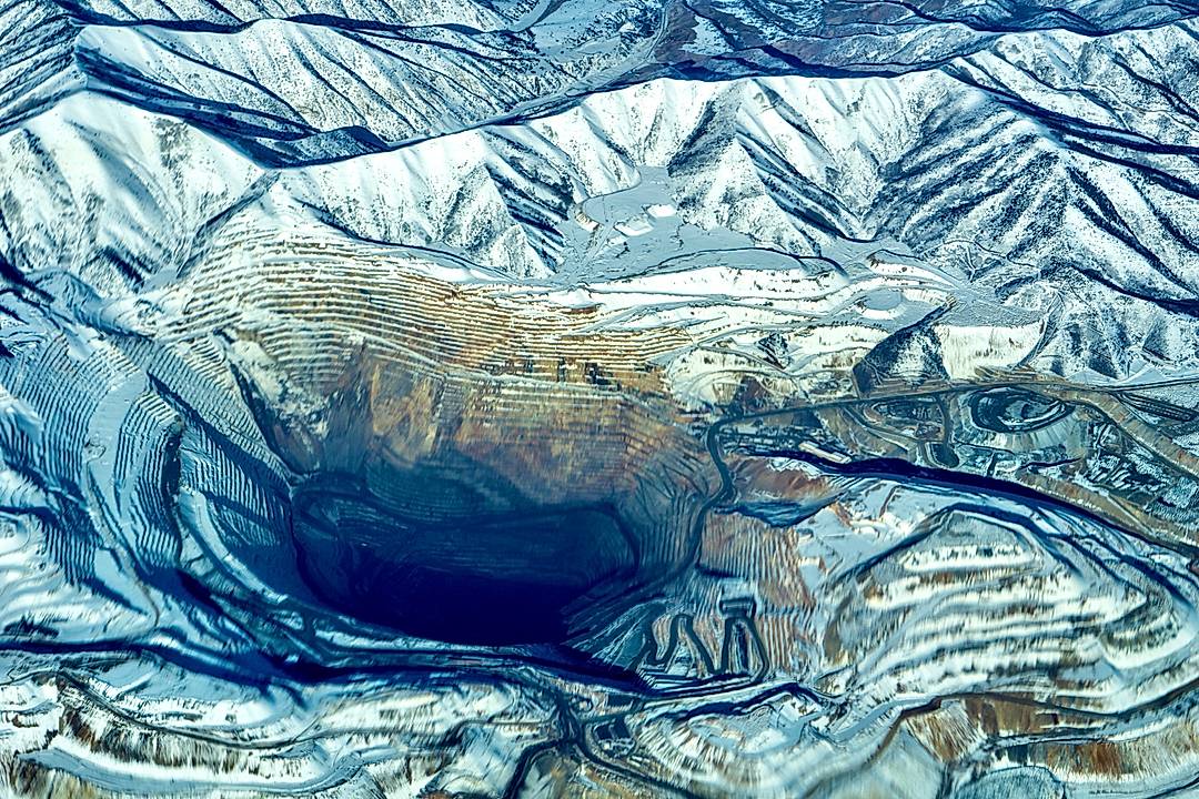 The Bingham Canyon Mine, more commonly known as Kennecott Copper Mine, is an open-pit mining operation extracting a large porphyry copper deposit southwest of Salt Lake City, Utah, in the Oquirrh Mountains. The mine is the largest human-made excavation, and deepest open-pit mine in the world, which is considered to have produced more copper than any other mine in history – more than 19,000,000 short tons (17,000,000 long tons; 17,000,000 t).