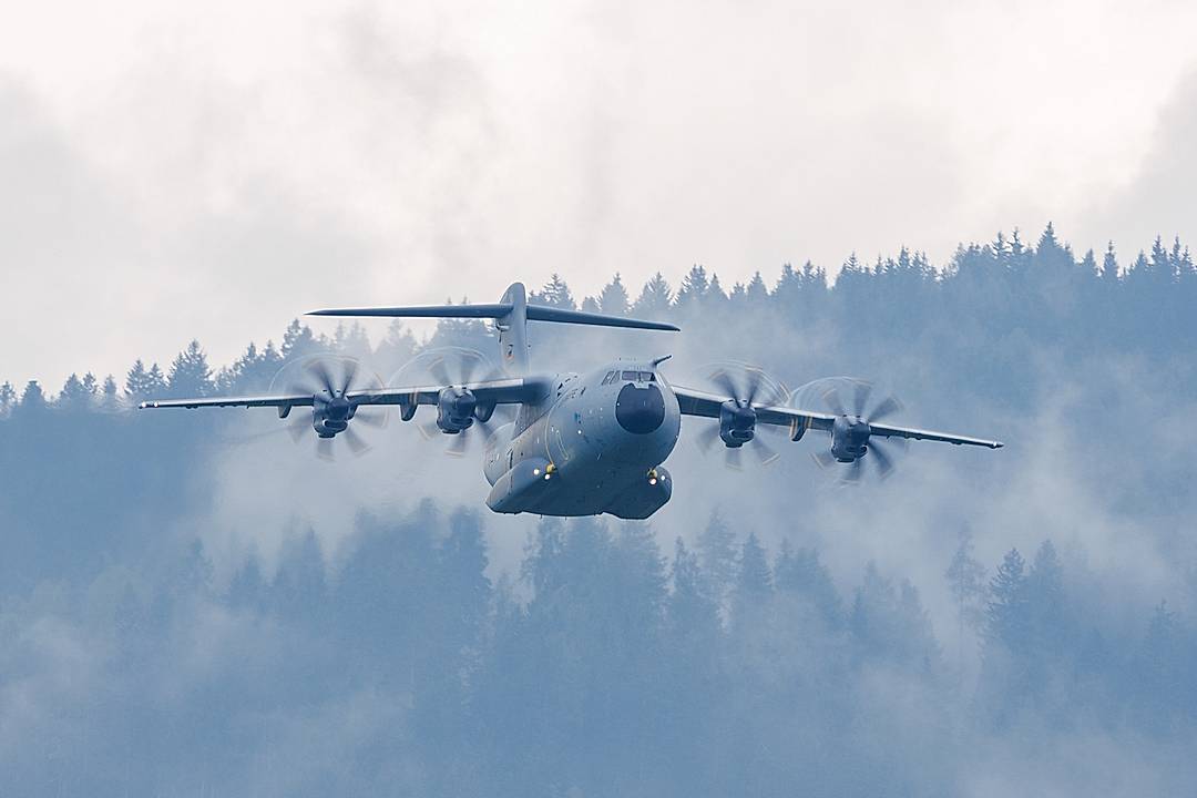 “A German A400 Atlas in front of the mountains with low-hanging clouds.“​​​​​​​​​​​​​​​​