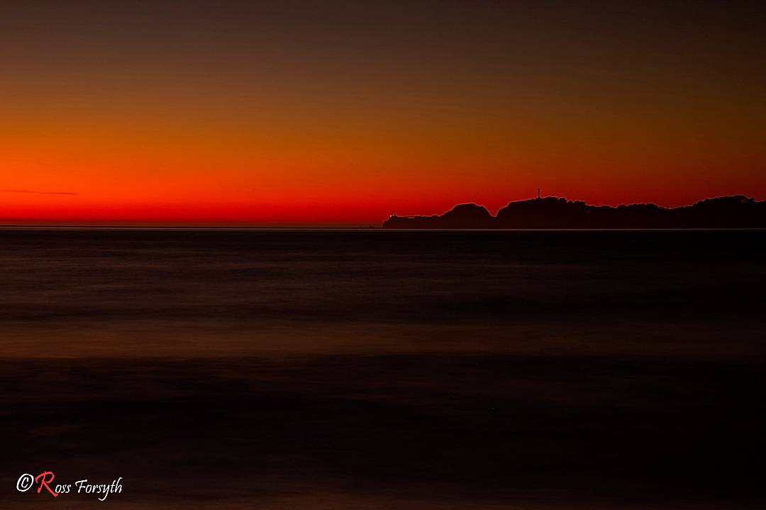 Pt Bonita Lighthouse across Golden Gate at sunset