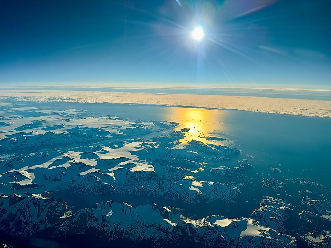 Sunrise over the East Coast of Greenland from 37,000 feet. 