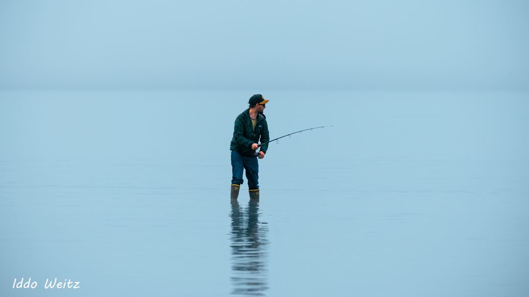 Fisherman fishing for salmon right beside the Valdez hatchery in Alaska