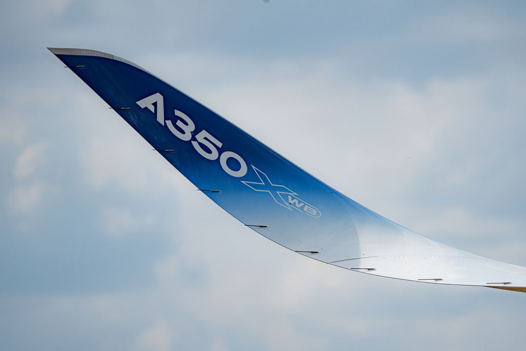 Super up close with the wingtip of the A350, almost blending in with the sky