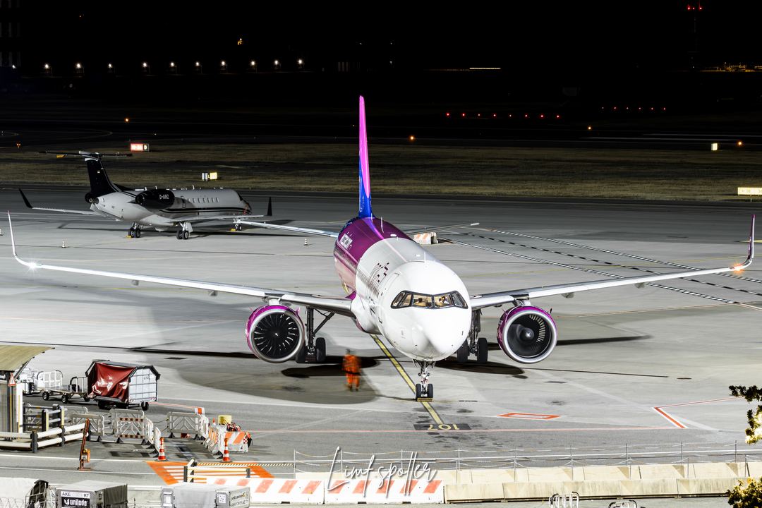 Wizz air a321 parked in turin airport, during night time.