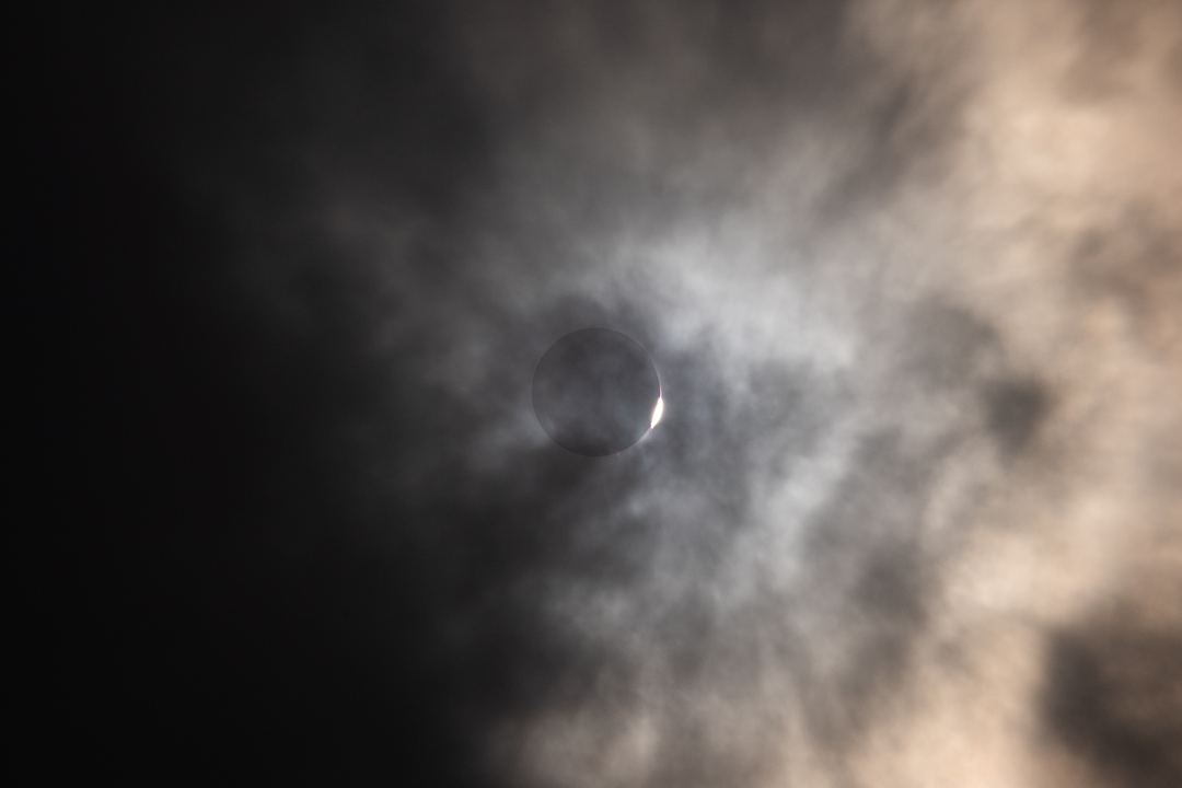 Diamond ring and shadow through the clouds from 2024 solar eclipse