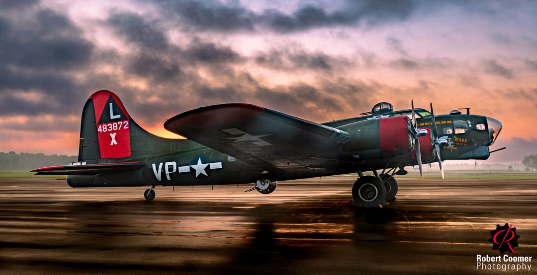 After the Morning Storm: B-17 Texas Raiders

Story: B-17 Texas Raiders basks in the glow of early morning light after a storm, surrounded by wet tarmac reflecting the colors of the sky. The image is an HDR composite of five exposures.

Intention: To create a beauty shot combining the aftermath of a storm, dramatic morning light, and this aging warrior.

Attention: The dramatic sky and warm reflections draw your eye into the frame, toward the aircraft silhouetted against the morning light.

Captivation: As your eye moves across the dark body of the B-17, details begin to emerge from the shadows. The uneven lighting reveals the aircraft a little at a time, while the reflections on the wet pavement draw you back into the scene.
