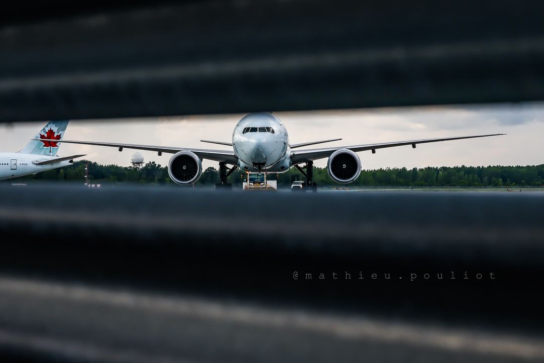 An other shot through the fence… Air Canada B777 on a tow move.