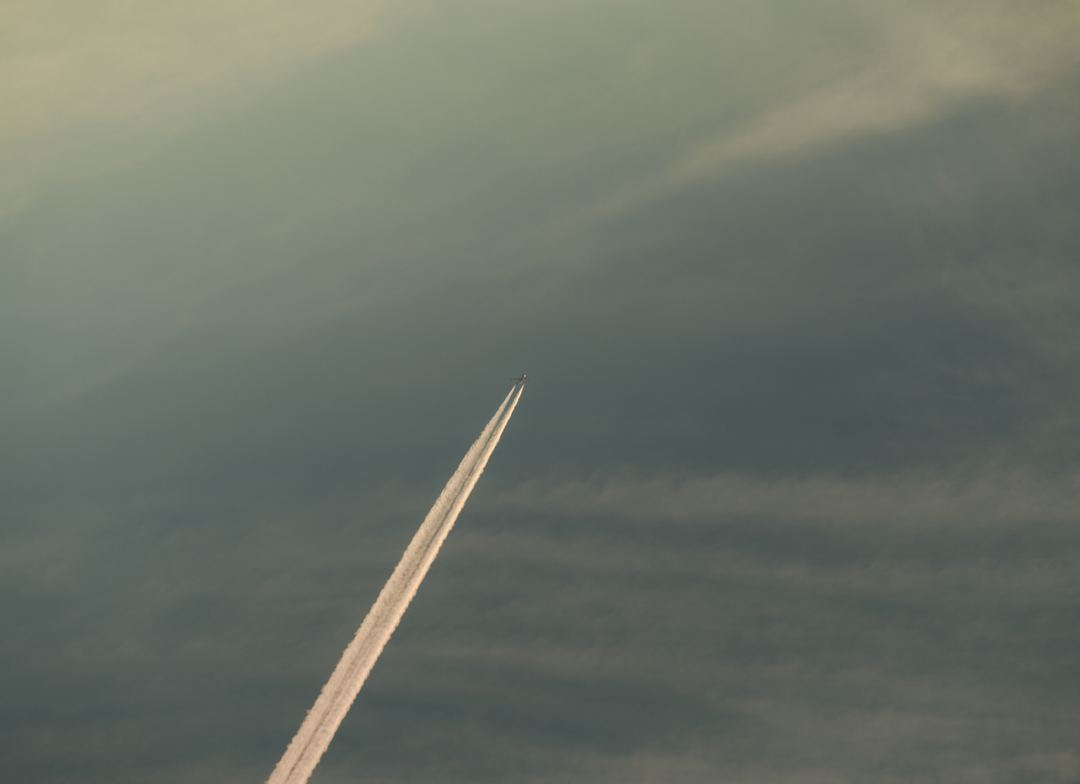 contrails in a smokey sky 