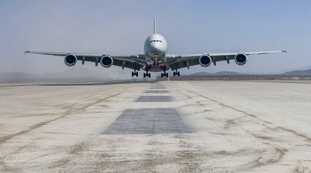 I was tiptoeing between black and white and enhancing the A380 but switched to adjusting the scenery.
I started with PS, copied the A380 into a picture showing one of  Edwards AFB dry lake runways. The dust cloud in the background is common for The valley of aviation and adds nicely to the A380 in landing configuration. Made some size adjustments and merged (harmonised) the picture with the background which resulted in some shadow on the left hand side and tone adjustment.
Transferred it to Lightroom for some effects, sharpening/noise reduction and shadow/highlight adjustments. 