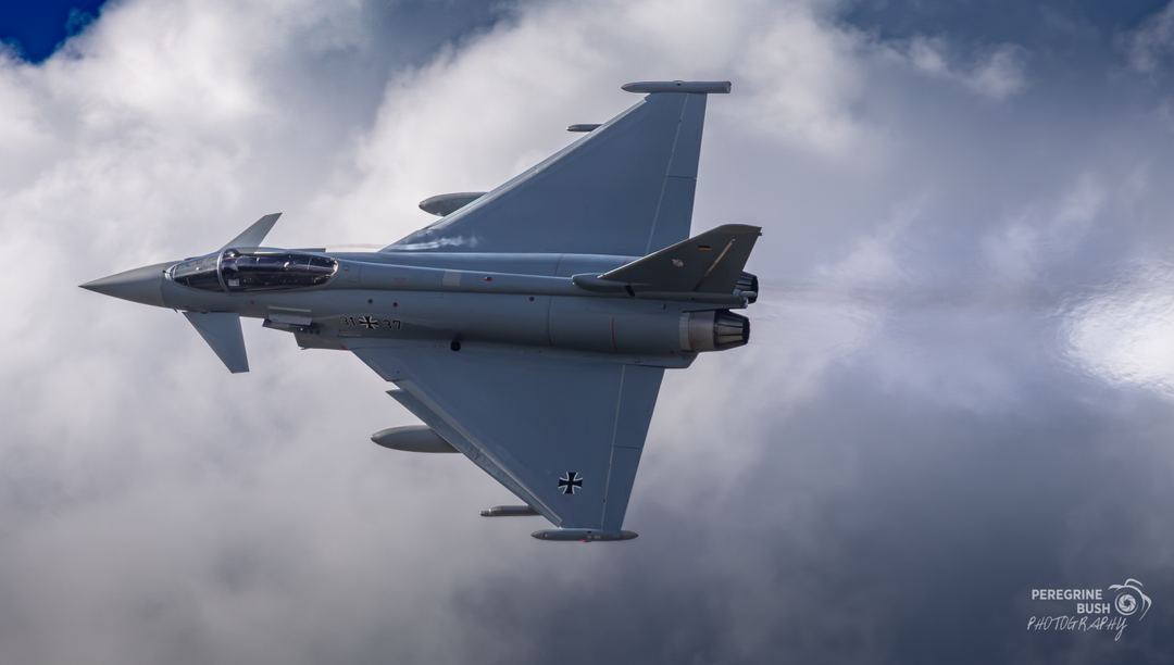 German Air Force Typhoons operating from RAF Cranwell during Cobra Warrior 26 2 . This machine banking hard from initials into the circuit.
