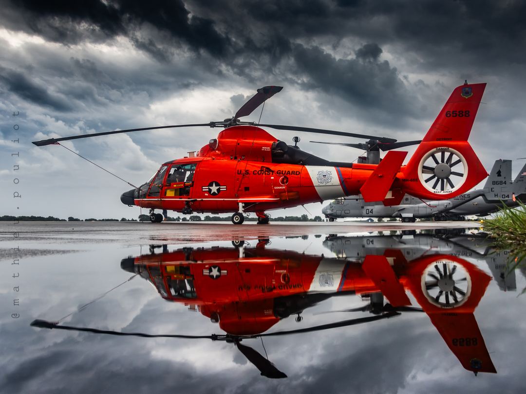 Airshow sunset tour delivered zero sun, but the ramp reflection made up for it. Mirror finish on this USCG MH-65E Dolphin to wrap up an overcast and rainy day.
