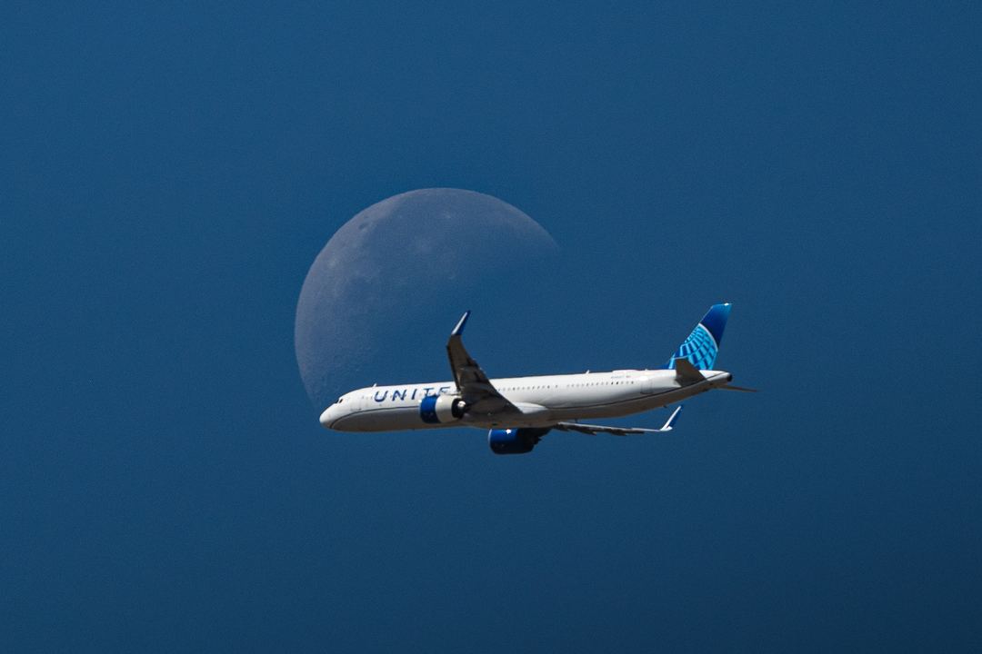 A nice moon crossing I caught today near Denver, of a departing A321 as the waning moon sets
