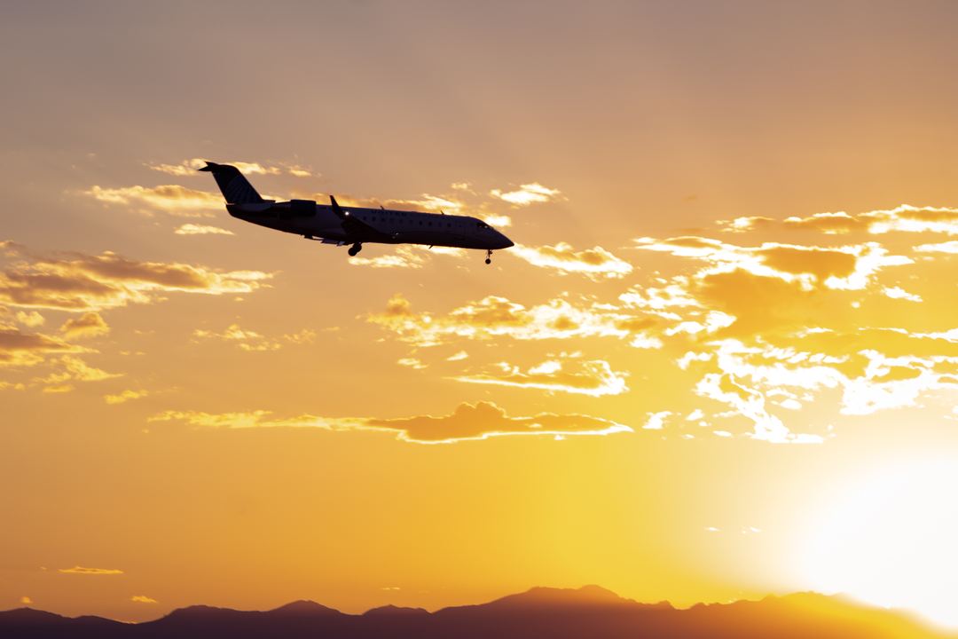 CRJ-200 flying into Denver during a beautiful sunset