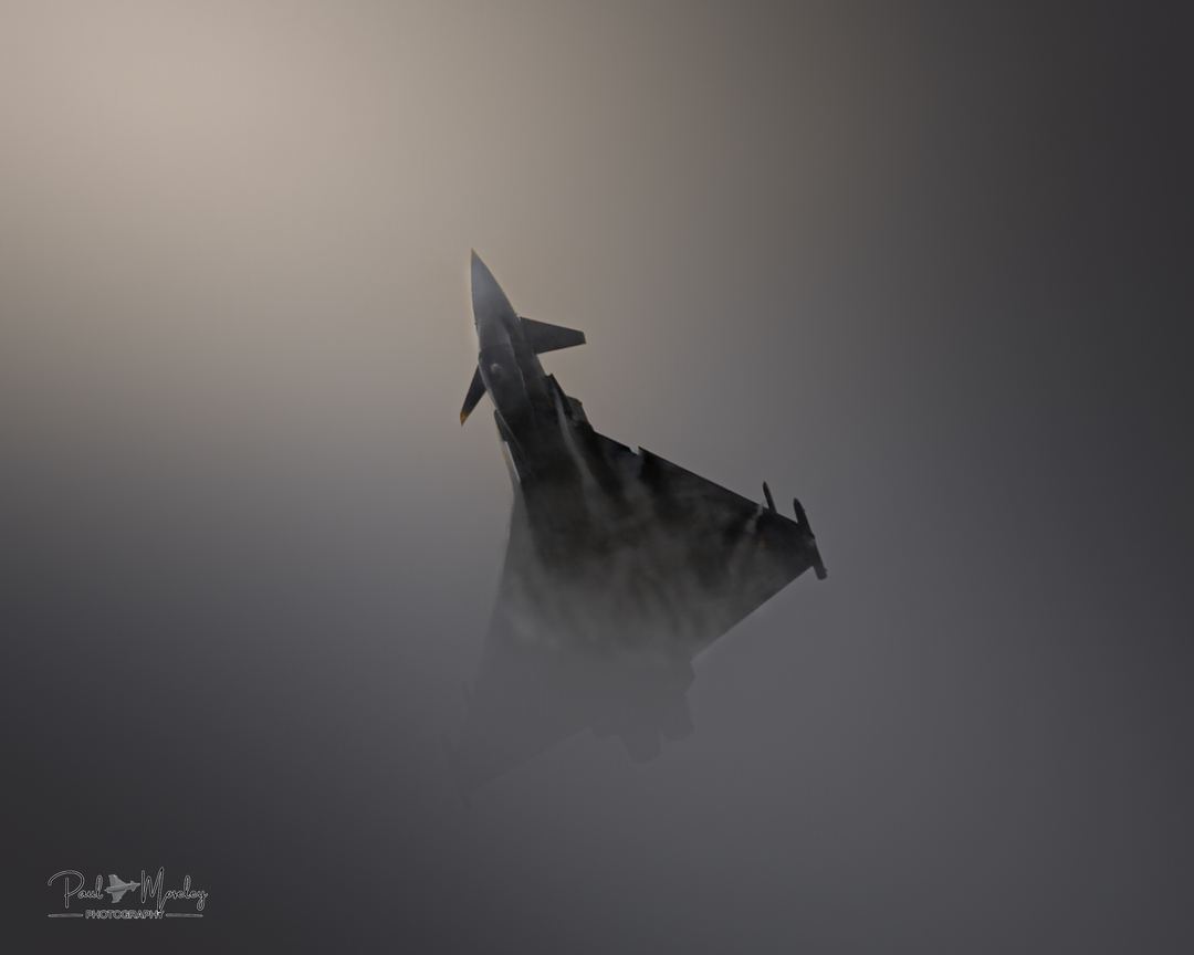 After the Storm

The Story – Spanish Display C.16 Tifon after a short storm at RIAT 25 it disappeared through the low clouds I caught it as it popped out. 

The Intention - I want the viewer to feel the atmosphere as it pops partly out the storm clouds. 

Attention the breaking sunlight hits the nose only seeing part of the aircraft. 

Captivation – that anticipation of the aircraft reappearing from the clouds the silhouette being drawn by the sunlight