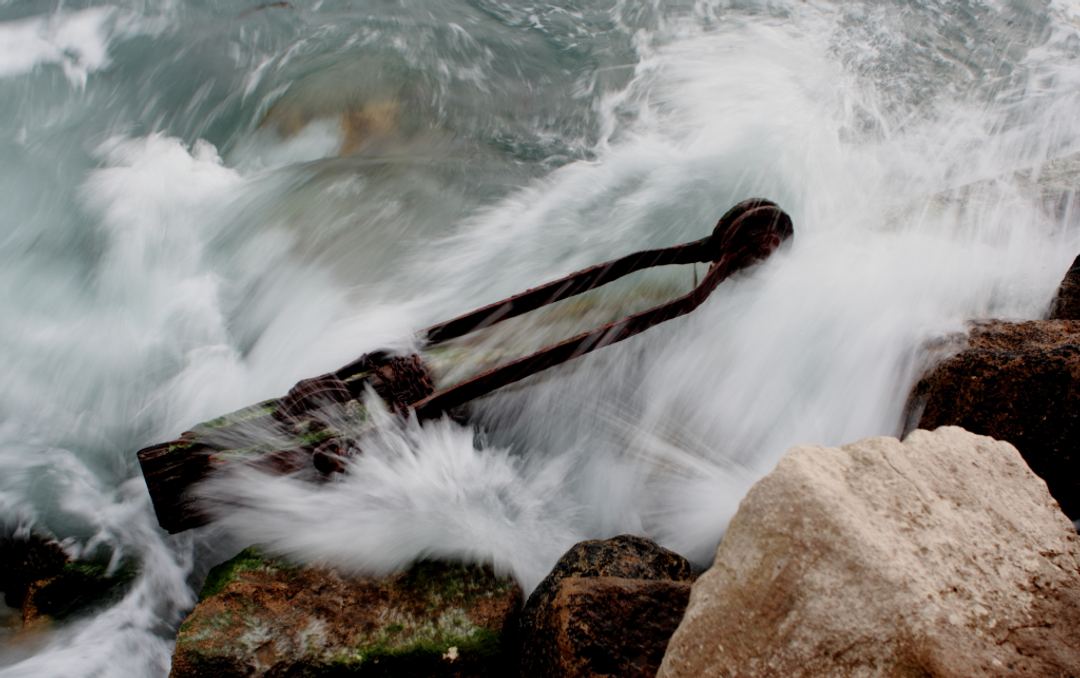 A part of an old crane which fell into the sea now being swamped again.
