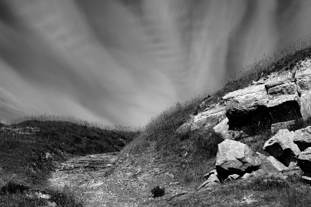 Choose this image because of the cloud formations and the track leading to them.