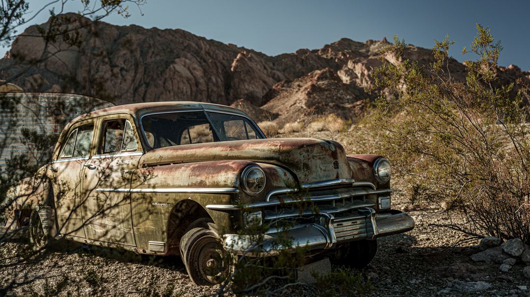 Nested between rugged hills in Southeastern Nevada and surrounded by infamous cholla cacti lies Nelson Ghost town.

 Once bustling mining town, it now attracts photographers and influencers who feverishly capture the numerous decayed vintage vehicles (and even a wreckage of a T-28 Trojan)  that have been gathered in and around the town. The hills around the town, other vehicles and Wild-West styled buildings provide an amazing backdrop for the subjects. 

One like myself could easily spend a whole day and even most of the night trying to capture all these in the changing light, unfortunately I did not have the luxury of staying there for long, but the visit was fruitful nonetheless.