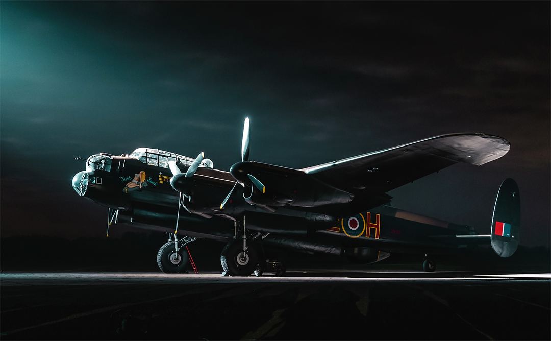 AVRO Lancaster NX611 'Just Jane' illuminated by the light of Lincolnshire Air Ambulance.