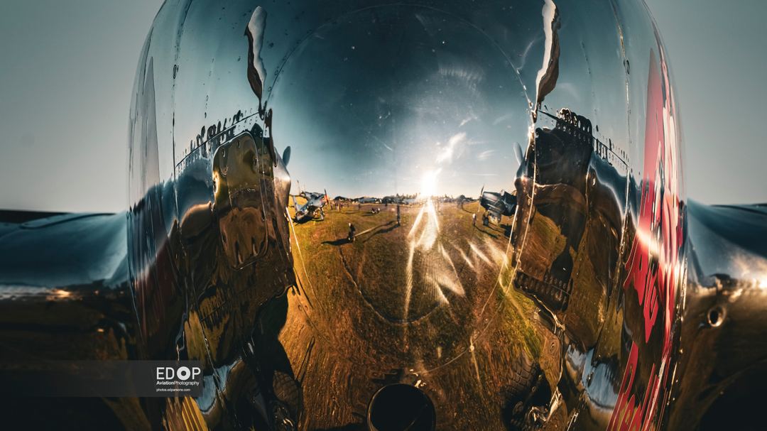 Reflections on Aviation Photography, fellow photographers reflected in the chrome of the Red Bulls P-38 at the Duxford Different Light Event.