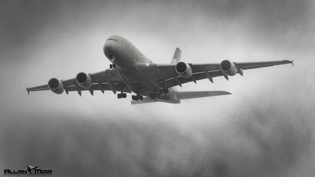 Etihad A380 appears out of the fog approaching 27L at Heathrow.