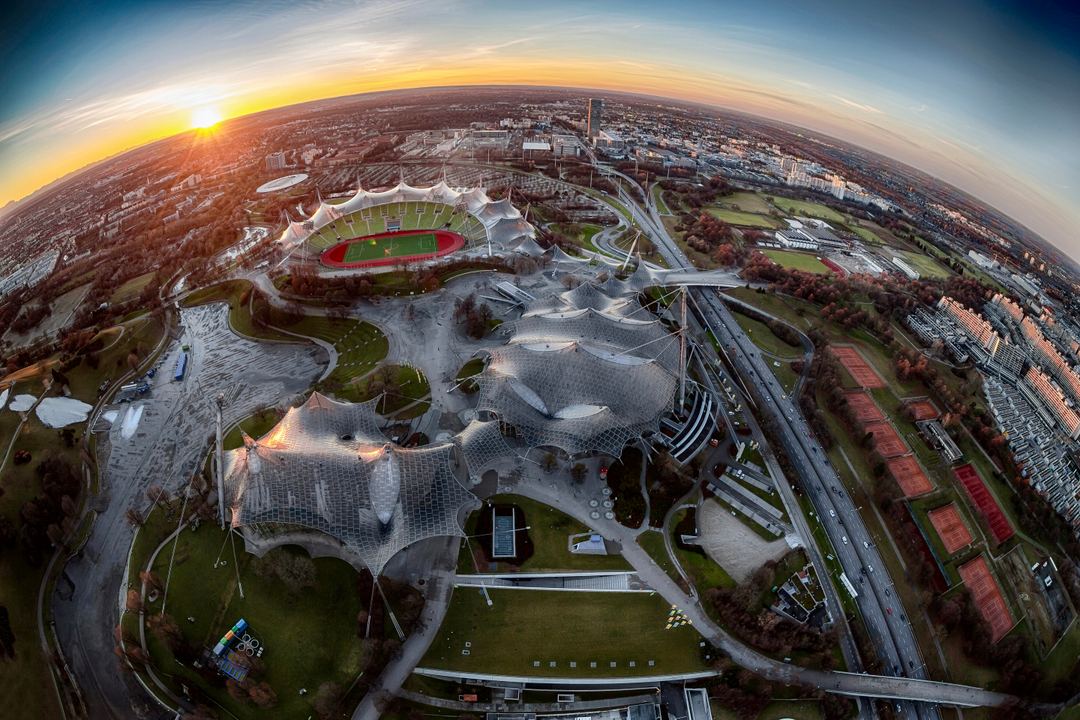 View over the city of Munich from the TV-Tower at sunset to the horizon, created with an  fisheye lens