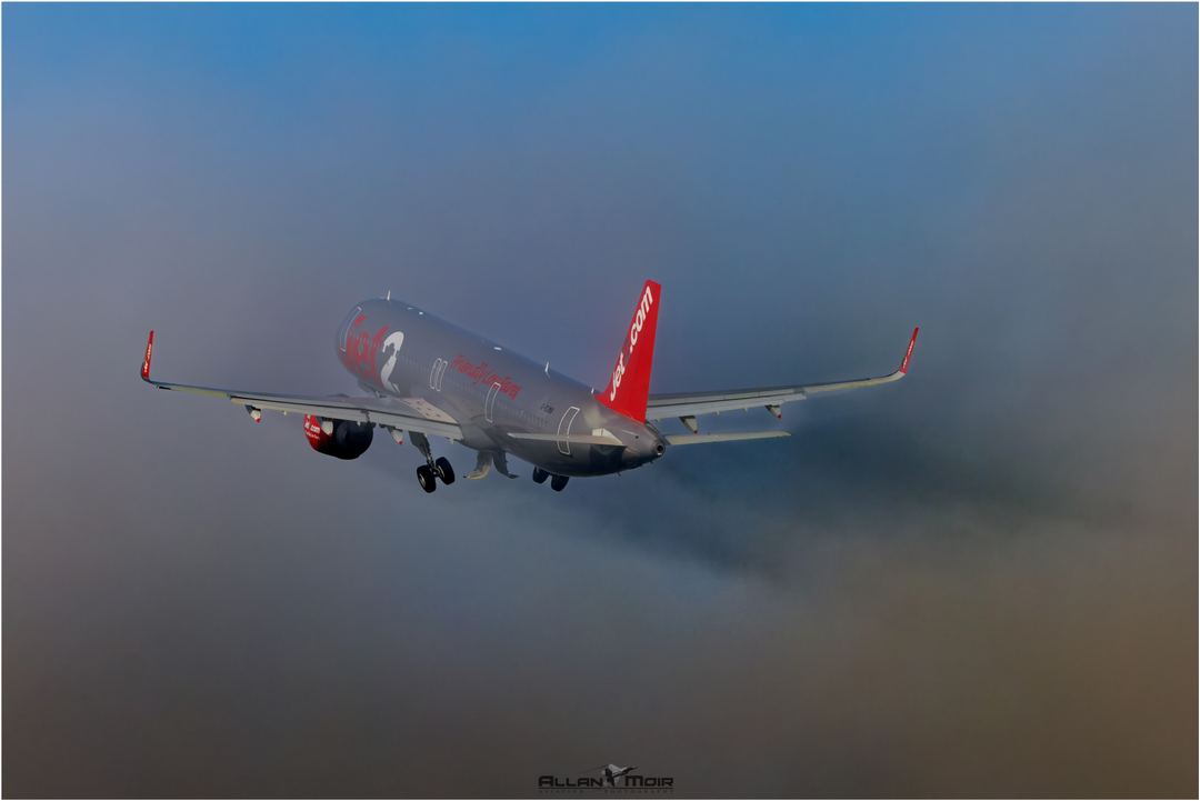 Jet2  A320 about to disappear into the fog after departing 23L at EGCC