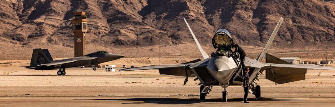 Raptors in action. Tactical demo F-22 lands while the demo F-22 gets ready for its show.