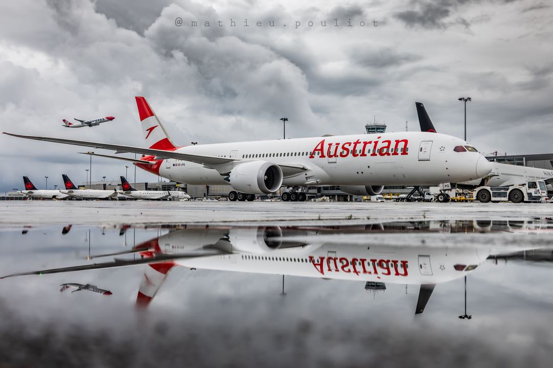 Austrian B787 being towed to its gate… with a little extra guest in the background departing.