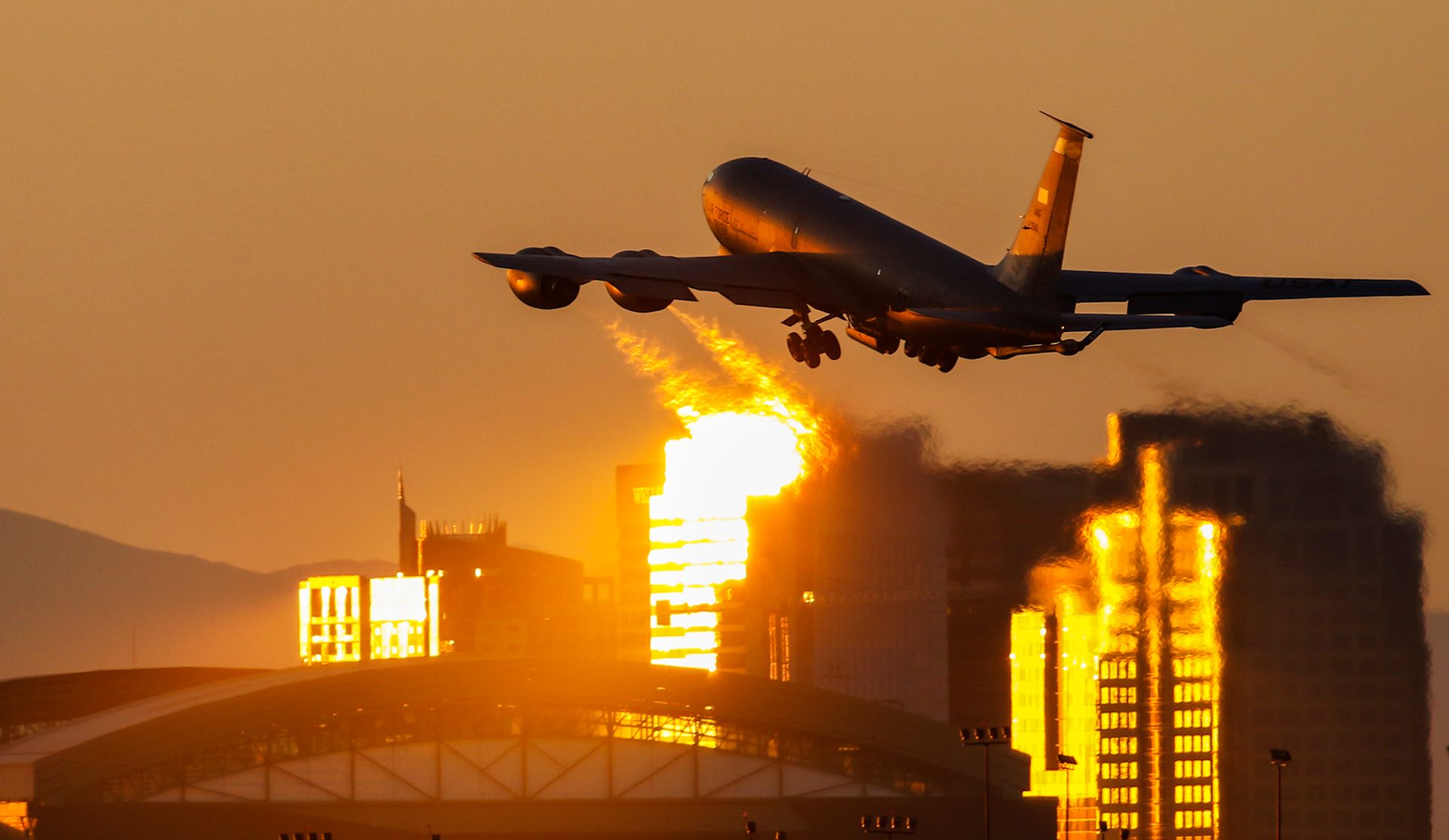 A KC-135 tanker departing Phoenix against a golden winter sunset